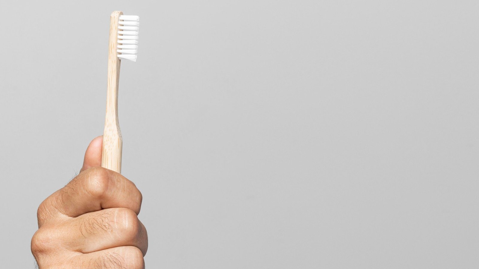 close-up-hand-holding-toothbrush